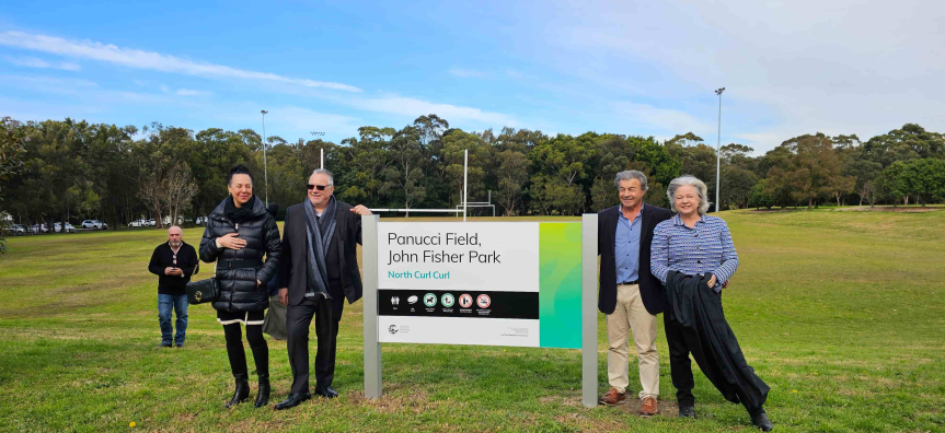 people standing next to new sign at Panucci Field