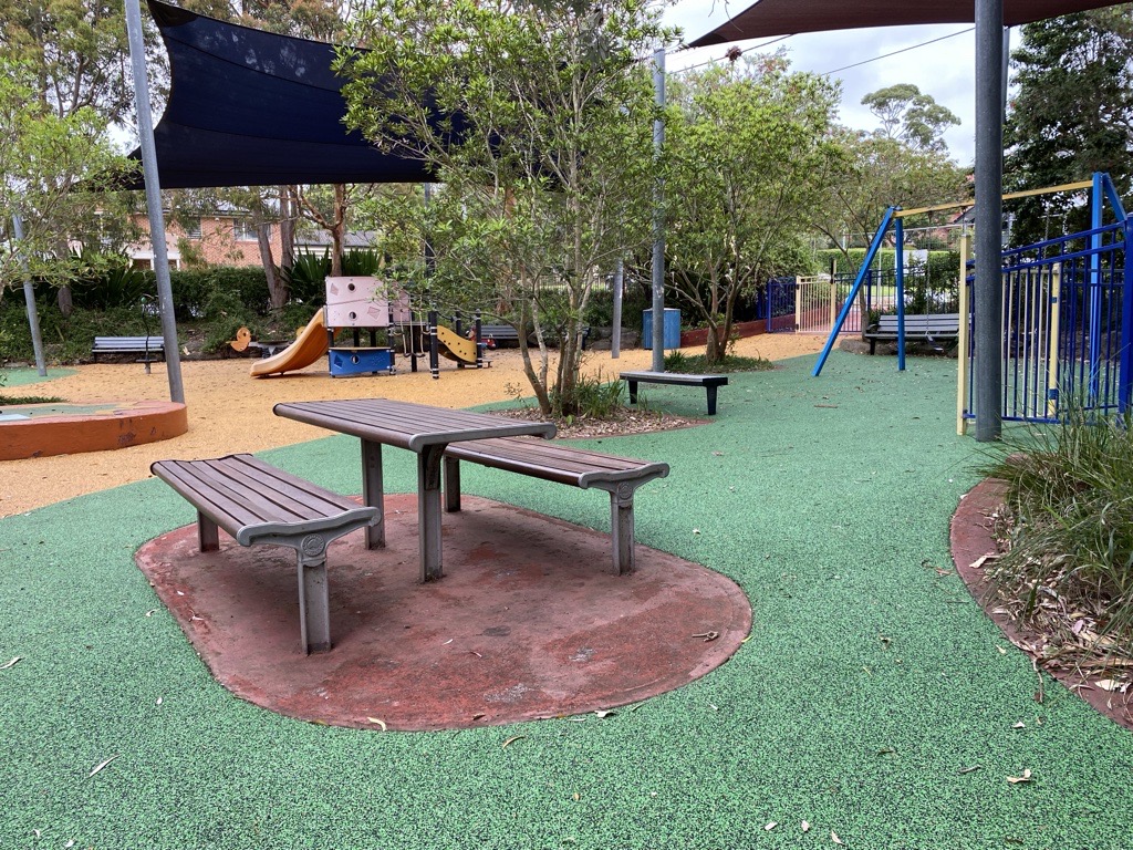 picnic table in front of play equipment