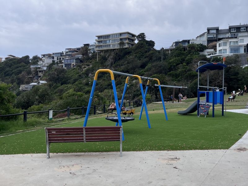 palyground equipment, ench seat, to people liying on a bench, people looking at view