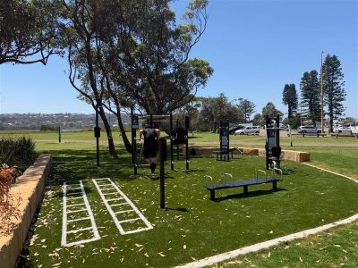 person using push-up bars in outdoor gym